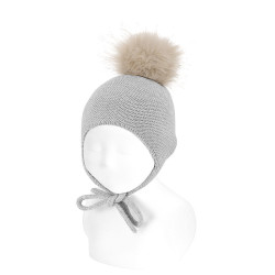 Buy Merino blend knit hat,earflaps and fauxfur pompom ALUMINIUM in the online store Condor. Made in Spain. Visit the ACCESSORIES FOR BABY section where you will find more colors and products that you will surely fall in love with. We invite you to take a look around our online store.