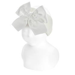 Buy Garter stitch headband with large grosgrain bow CREAM in the online store Condor. Made in Spain. Visit the HAIR ACCESSORIES section where you will find more colors and products that you will surely fall in love with. We invite you to take a look around our online store.